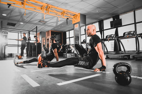 Homme à la salle de sport qui fait un exercice de musculation